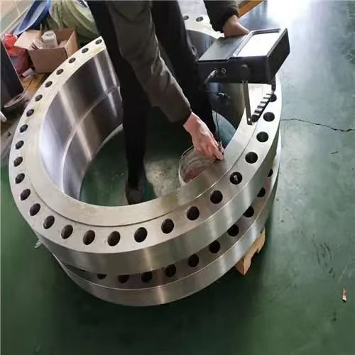 Engineers are performing non-destructive testing on flanges