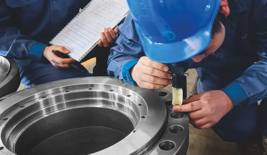 Engineers are performing non-destructive testing on flanges