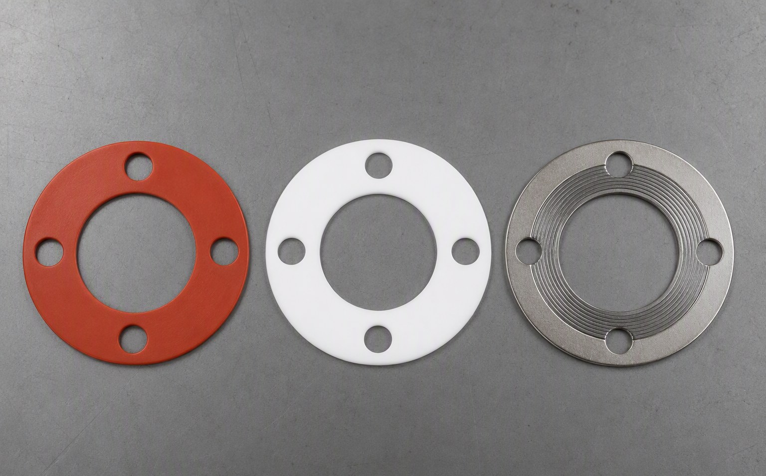 Silicone (red), PTFE (white) and spiral wound (steel) gaskets side by side